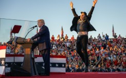 Elon Musk (R) has become an enthusiastic supporter of Donald Trump (L)