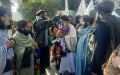 Taliban authorities welcomed Afghan fighter Khan Mohammed (C) who was imprisoned in the United States, as he arrived in Jalalabad in eastern Nangarhar province
