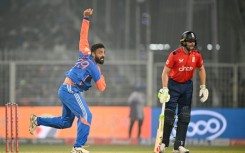India's Varun Chakravarthy (L) took three wickets, including the crucial scalp of Jos Buttler (R)