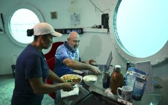 Rudiger Koch has breakfast in his underwater home before emerging as a world record holder