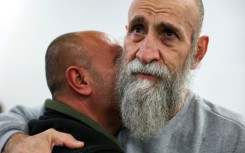 A well-wisher embraces freed prisoner Raed al-Saadi, 56, who spent 36 years behind bars.