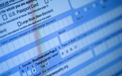 A partially completed passport application, with an 'X' gender marker, is seen on a computer monitor in 2022
