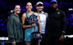 Madison Keys stands alongside husband and coach Bjorn Fratangelo with her team after lifting the Australian Open trophy