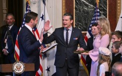 Pete Hegseth (C) -- surrounded by his wife and children -- is sworn in as the new US secretary of defense by Vice-President JD Vance (L)