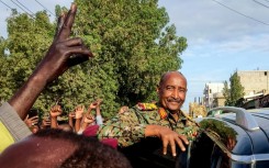People cheer Sudan's de facto leader, armed forces chief Abdel Fattah al-Burhan, at the market in Port Sudan on December 29, 2024