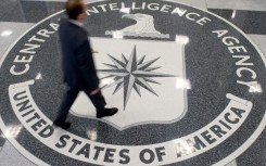 A man crosses the Central Intelligence Agency (CIA) seal in the lobby of CIA Headquarters in Langley, Virginia in August 2008