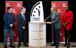 Former President of Colombia Juan Manuel Santos (second to left) and other experts unveil the Doomsday Clock at 89 seconds to midnight at a news conference in Washington