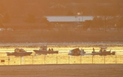 Rescuers on boats search the waters of the Potomac River after a plane carrying several elite figure skaters crashed near Washington's Reagan National Airport 