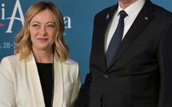 Italy's Prime Minister Giorgia Meloni greets Tunisia's President Kais Saied