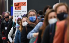 Climate activists hold a protest action during the COP26 UN Climate Change Conference in Glasgow on November 12, 2021