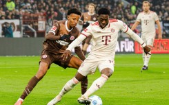 Bayern Munich defender Alphonso Davies, R, has signed a five-year extension with the club.