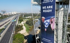 A billboard bearing a picture of US President Donald Trump and Saudi Crown Prince Mohammed bin Salman is seen on a building in Ramat Gan, Israel