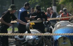 Police investigadors work at the site of a plane accident in Sao Paulo, Brazil