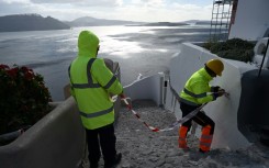 Council workers restrict access to the village of Oia on Santorini