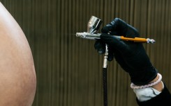 An employee paints on a fake pregnant belly made for cinema and television created by Cinebebe in Paris