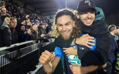 Shock victory: Stade Briochin's Leo Yobe celebrates with a fan