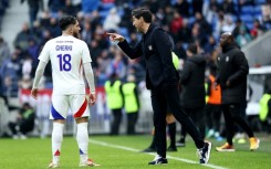 New Lyon coach Paulo Fonseca (R) speaks with Rayan Cherki during the 4-0 win over Reims in Ligue 1 on Sunday
