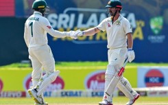 Australia's Usman Khawaja (left) and teammate Travis Head bump fists on the fourth day of the second Test against Sri Lanka in Galle