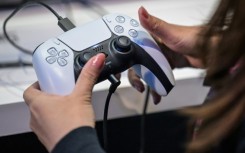 A member of the media tries out Sony's PlayStation 5 console during the Tokyo Game Show in Chiba City on September 26, 2024