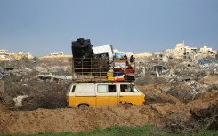 Displaced Palestinians cross the Netzarim Corridor as they make their way to the northern parts of the Gaza Strip