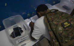 A student leaves his cellphone at the beginning of the school day at Reverend Martin Luther King public school in Rio de Janeiro