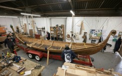 Veterans put the finishing touches to a Viking longboat built from solid oak using authentic Scandinavian plans as part of a project to help restore their mental health 