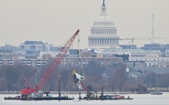 A crane removes wreckage from the Potomac River of American Eagle Flight 5342, which collided with a US Army helicopter near Ronald Reagan National Airport