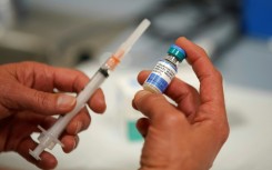 A one dose bottle of measles, mumps and rubella virus vaccine, made by MERCK, is held up at the Salt Lake County Health Department on April 26, 2019 in Salt Lake City, Utah