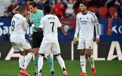 Flashpoint: Real Madrid's Kylian Mbappe and Vinicius Junior remonstrate with referee Jose Munuera over the red card given to Jude Bellingham (R)