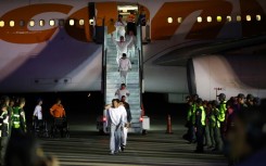 Venezuelan migrants deported from US Naval Station Guantanamo Bay walk down from the Venezuelan Conviasa Airlines plane as they arrive at Simon Bolivar International Airport in Maiquetia, Venezuela on February 20, 2025