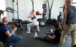Adult movie director Casey Calvert (seated) and Eli Cross (L) rehearse for a scene with pornographic actress Lilly Bell (C) in Northridge, California