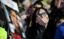 A woman reacts at 'Hostages Square' in Tel Aviv, where crowds gathered after militants in Gaza handed over the bodies of Israeli captives