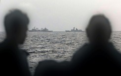 Sailors aboard an Australian navy ship look out at Chinese vessels on February 13, picture by the Australian Defence Force