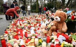 A memorial of candles, flowers and soft toys for the victims of a knife attack in Aschaffenburg where police arrested an Afghan man as the main suspect