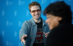 Robert Pattinson and South Korean director Bong Joon Ho pose during a photo call 