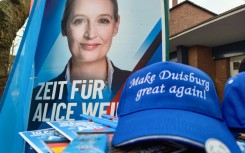 A poster of the Alternative for Germany's Alice Weidel and a 'Make Duisburg Great Again' cap at a stall of the far-rigth party in the western industrial town