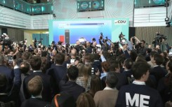 Supporters of Germany's conservatives cheer as exit polls predict win