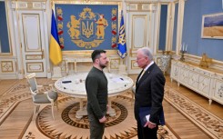 Ukraine's President Volodymyr Zelensky greets US special envoy for Ukraine Keith Kellogg at his offices in Kyiv on February 20, 2025