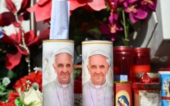 A hand written message is placed in a candle of Pope Francis outside the Gemelli hospital 