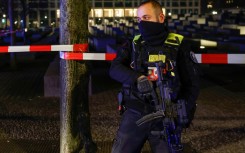 An armed police officer at the cordoned off scene of the stabbing attack