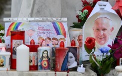 Candles, flowers and portraits of Pope Francis have been laid at the statue of the late John Paul II outside the Gemelli hospital where Pope Francis is hospitalized with double pneumonia