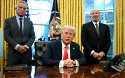 US President Donald Trump speaks to the press alongside Secretary of Health and Human Services Robert F. Kennedy Jr (L) and Secretary of Commerce Howard Lutnick (R) on February 25, 2025