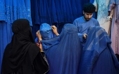 Afghan women buy burqas at a shop in Mazar-i-Sharif. When the Taliban recaptured Kabul in 2021, they had promised to be more flexible than during their first rule