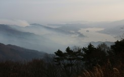 Smoke rises from a wildfire near Ofunato Bay in Iwate Prefecture