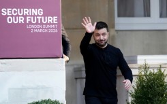 Ukraine's President Volodymyr Zelensky waves while attending a summit at Lancaster House in central London