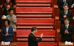 China's President Xi Jinping arrives for the opening session of the National People's Congress (NPC) on Wednesday