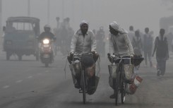 Commuters drive through heavy smog in New Delhi on November 2017