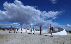Dancers perform in front of  French-American artist Sarah Meyohas's piece 'Truth Arrives in Slanted Beams' ahead of the opening of the Desert X exhibit spread across California's Coachella Valley 