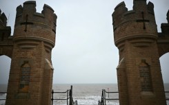 View of the North Sea between the turrets of the entrance to the old pier in Withernsea, on the east coast of England near where a collision between a tanker and a cargo ship caused multiple explosions