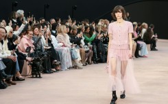 A pink tailored short ensemble was layered with a sheer jacket and matching long transparent skirt